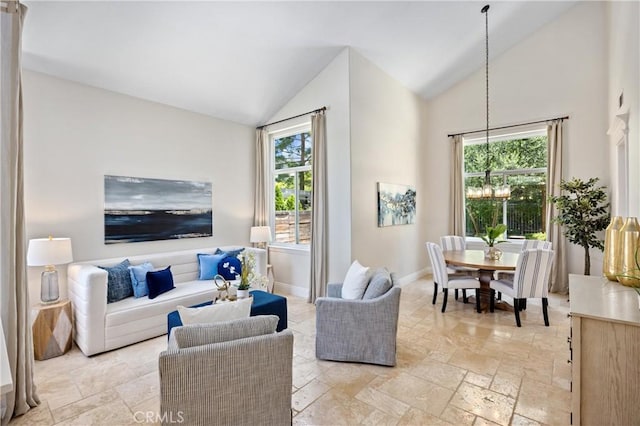 18 Via Tigra, Rancho Santa Margarita, CA 92688 - living area featuring healthy amount of natural light, stone tile floors, and high vaulted ceiling