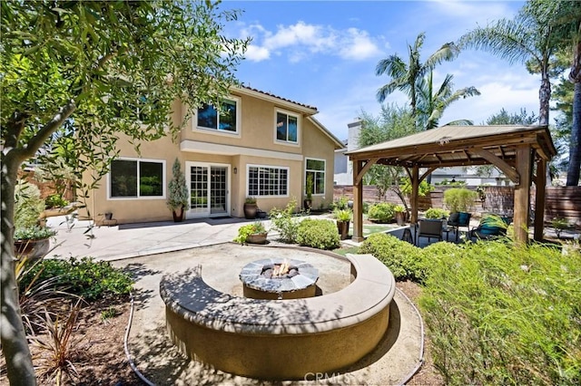 18 Via Tigra, Rancho Santa Margarita, CA 92688 - back of house with a gazebo, a fire pit, a patio, and stucco siding