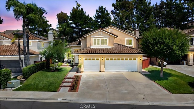 18 Via Tigra, Rancho Santa Margarita, CA 92688 - view of front of home with driveway, stucco siding, a front yard, and a garage