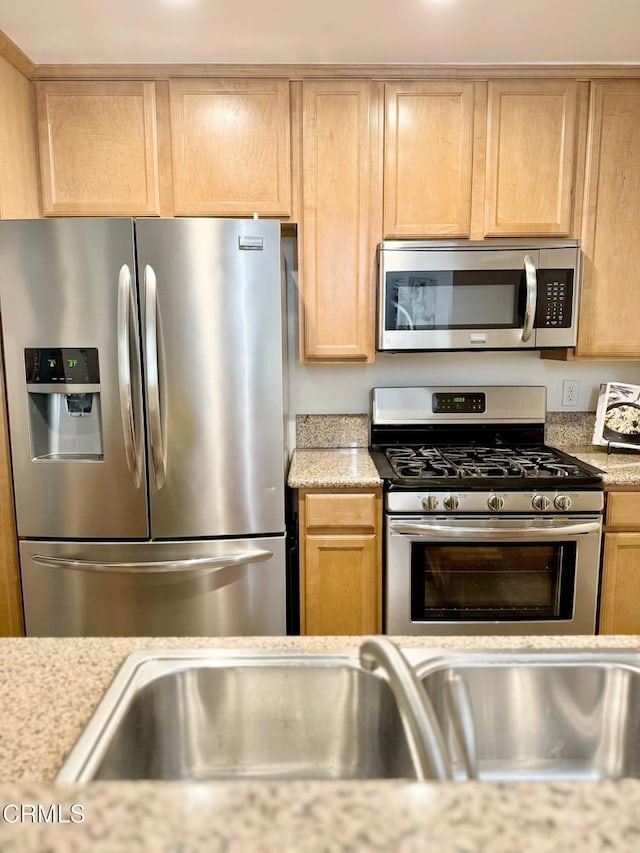 501 E Del Mar Blvd Unit 303, Pasadena, CA 91101 - kitchen featuring appliances with stainless steel finishes, light brown cabinets, and light stone countertops