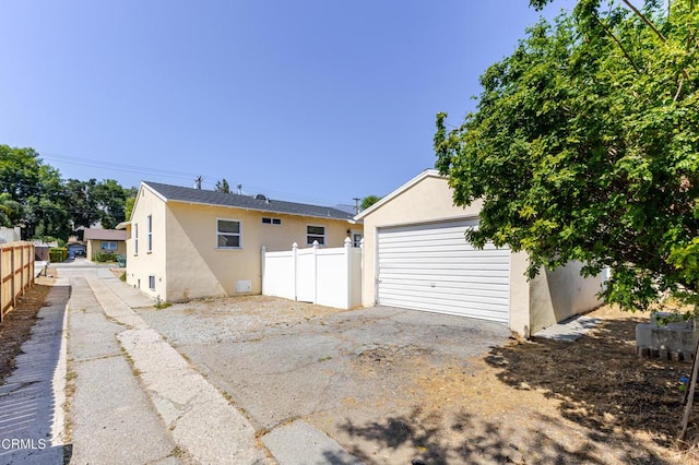 1500 E Topeka St, Pasadena, CA 91104 - back of house featuring stucco siding, an outdoor structure, and a detached garage