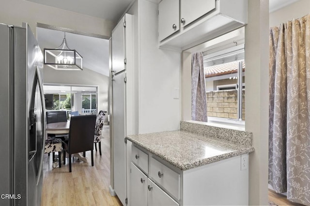 1716 Shoreline St, Camarillo, CA 93010 - kitchen featuring stainless steel refrigerator with ice dispenser, a chandelier, white cabinets, light wood finished floors, and vaulted ceiling