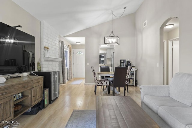 1716 Shoreline St, Camarillo, CA 93010 - living area featuring light wood-style floors, arched walkways, and lofted ceiling