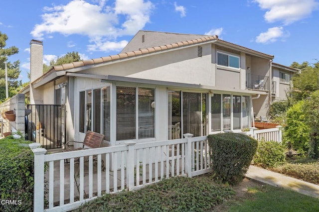 1716 Shoreline St, Camarillo, CA 93010 - view of side of property featuring a sunroom, a chimney, a tile roof, and stucco siding