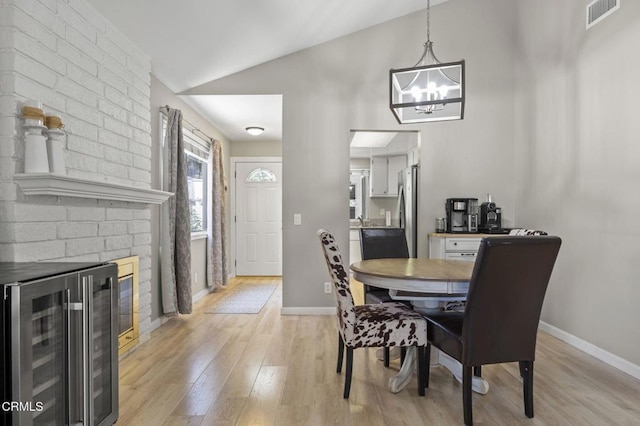 1716 Shoreline St, Camarillo, CA 93010 - dining space featuring beverage cooler, light wood finished floors, a chandelier, and lofted ceiling