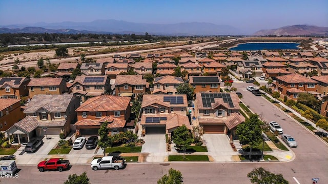 665 Tiber River Way, Oxnard, CA 93036 - view of building exterior featuring a garage, driveway, a residential view, and a water and mountain view