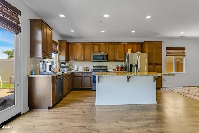 665 Tiber River Way, Oxnard, CA 93036 - kitchen featuring appliances with stainless steel finishes, plenty of natural light, a breakfast bar, tasteful backsplash, and recessed lighting