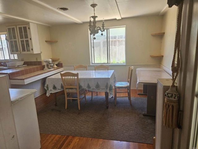 733 Cathy, Cardiff By The Sea, CA 92007 - dining room featuring wood finished floors, a chandelier, and a wainscoted wall