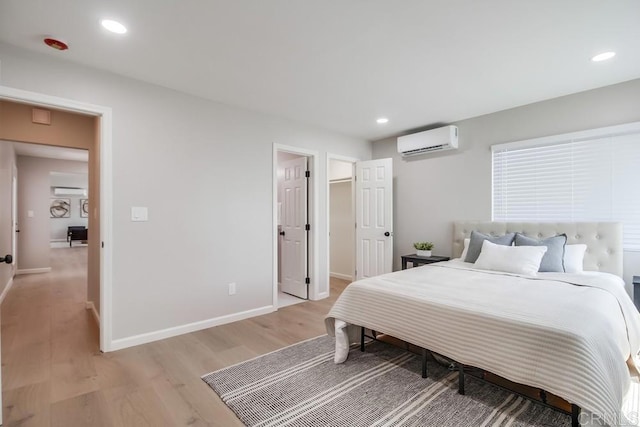 3629 Gilmore St, San Diego, CA 92113 - bedroom with an AC wall unit, light wood-style floors, recessed lighting, and a walk in closet