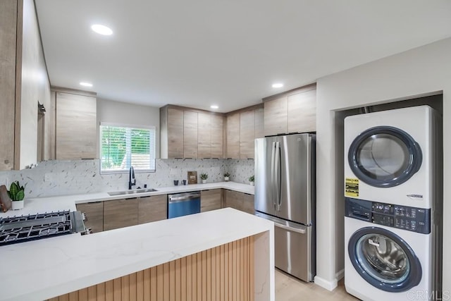 3629 Gilmore St, San Diego, CA 92113 - kitchen featuring estacked washer and dryer, stainless steel appliances, light countertops, decorative backsplash, and recessed lighting