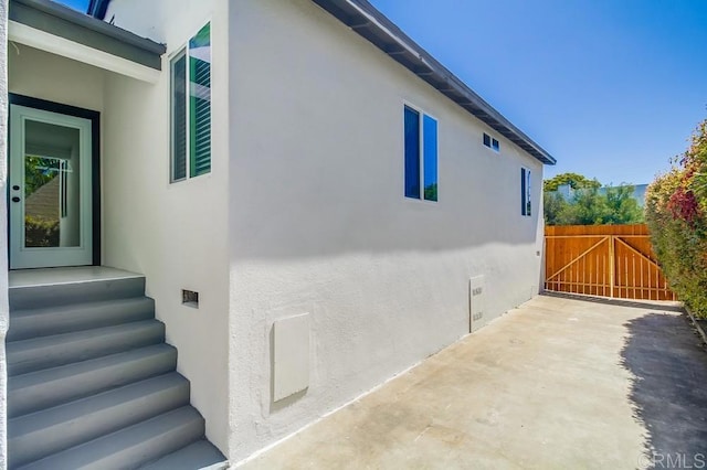 3629 Gilmore St, San Diego, CA 92113 - view of home's exterior featuring stucco siding, a patio, and a gate
