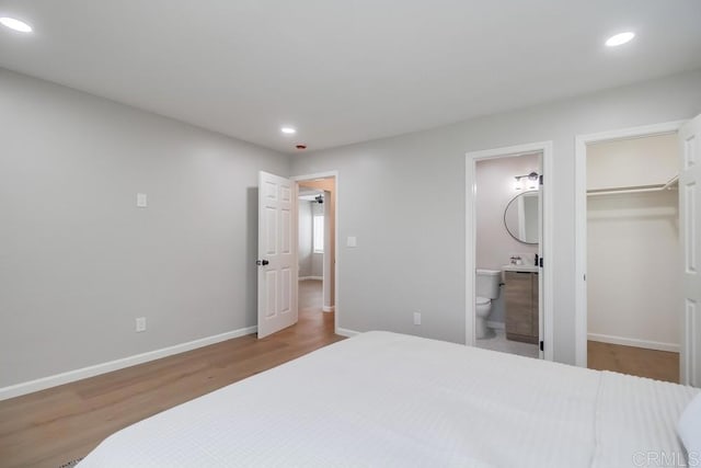 3629 Gilmore St, San Diego, CA 92113 - bedroom with recessed lighting, wood finished floors, a walk in closet, connected bathroom, and a closet