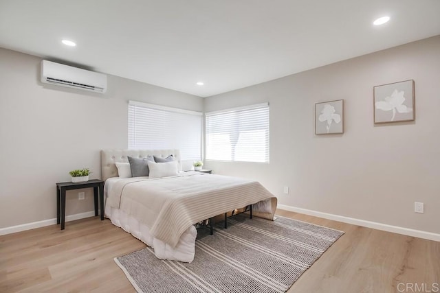 3629 Gilmore St, San Diego, CA 92113 - bedroom featuring an AC wall unit, light wood-style flooring, and recessed lighting