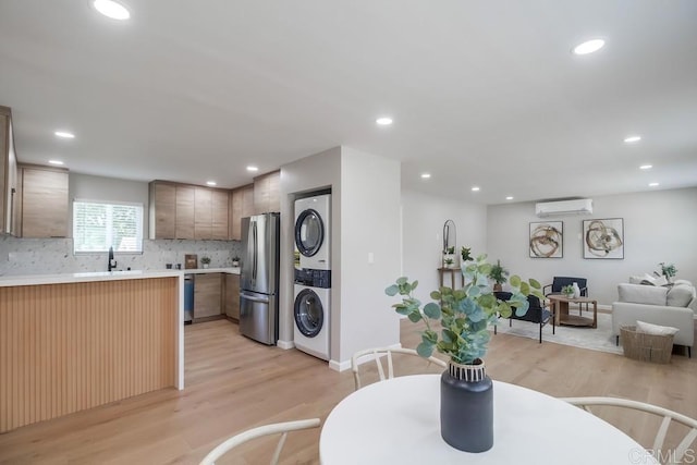 3629 Gilmore St, San Diego, CA 92113 - dining room featuring stacked washer and clothes dryer, a wall mounted air conditioner, light wood-style floors, and recessed lighting