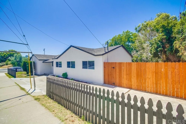 3629 Gilmore St, San Diego, CA 92113 - view of side of property with stucco siding and a shingled roof