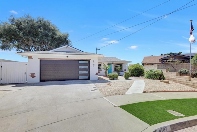 4107 Cole Way, San Diego, CA 92117 - view of front facade featuring concrete driveway, an attached garage, and stucco siding
