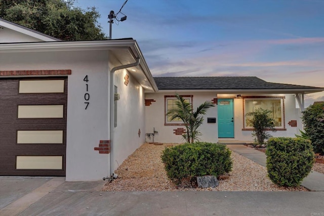 4107 Cole Way, San Diego, CA 92117 - exterior entry at dusk featuring stucco siding and a garage