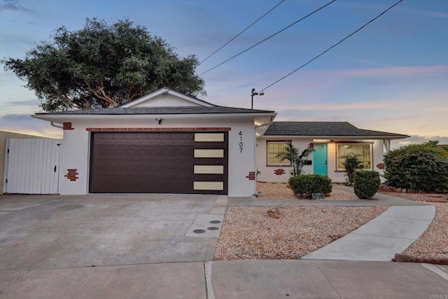 4107 Cole Way, San Diego, CA 92117 - view of front of house with an attached garage, driveway, and stucco siding