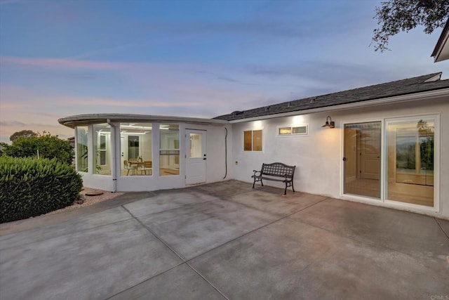 4107 Cole Way, San Diego, CA 92117 - back of house at dusk with a patio, a sunroom, and stucco siding