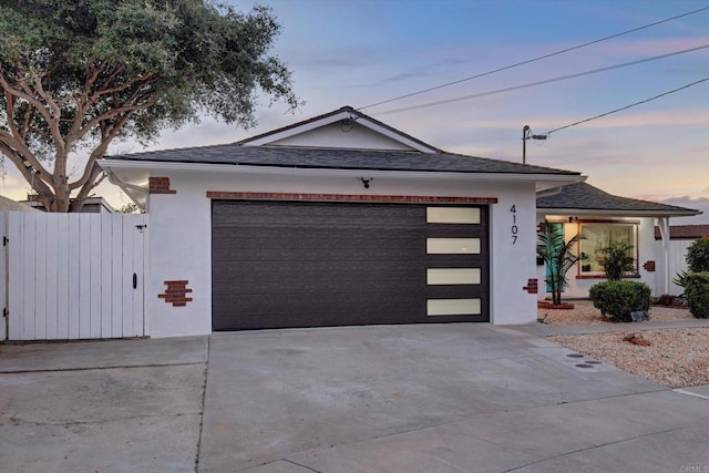 4107 Cole Way, San Diego, CA 92117 - view of front of property with concrete driveway, an attached garage, stucco siding, and a shingled roof