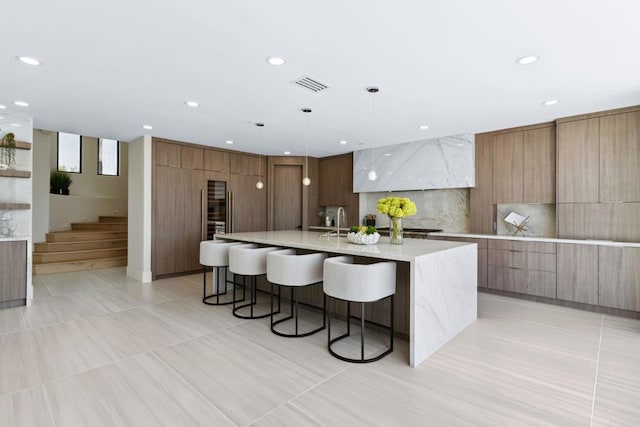 9355 Lavell St, La Mesa, CA 91941 - kitchen featuring modern cabinets, a kitchen bar, a large island with sink, pendant lighting, and recessed lighting