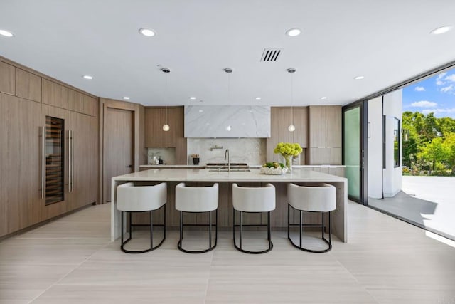9355 Lavell St, La Mesa, CA 91941 - kitchen featuring modern cabinets, a breakfast bar, wine cooler, decorative backsplash, and recessed lighting