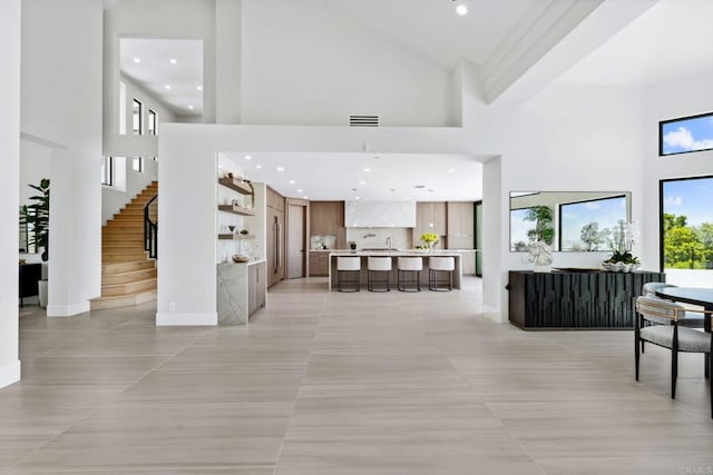 9355 Lavell St, La Mesa, CA 91941 - living room with high vaulted ceiling, light tile patterned flooring, recessed lighting, and stairway