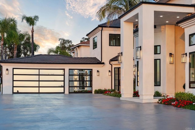 9355 Lavell St, La Mesa, CA 91941 - modern home featuring concrete driveway, stucco siding, a tiled roof, and a garage