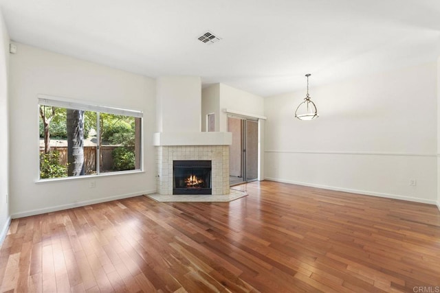 12032 Calle De Medio Unit 169, El Cajon, CA 92019 - unfurnished living room featuring hardwood / wood-style floors and a tile fireplace