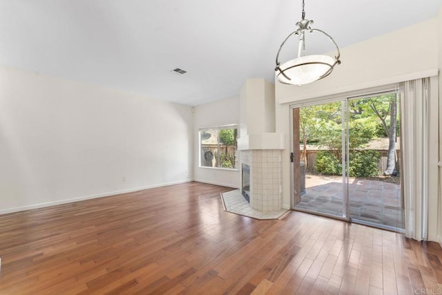 12032 Calle De Medio Unit 169, El Cajon, CA 92019 - unfurnished living room with wood finished floors and a tile fireplace