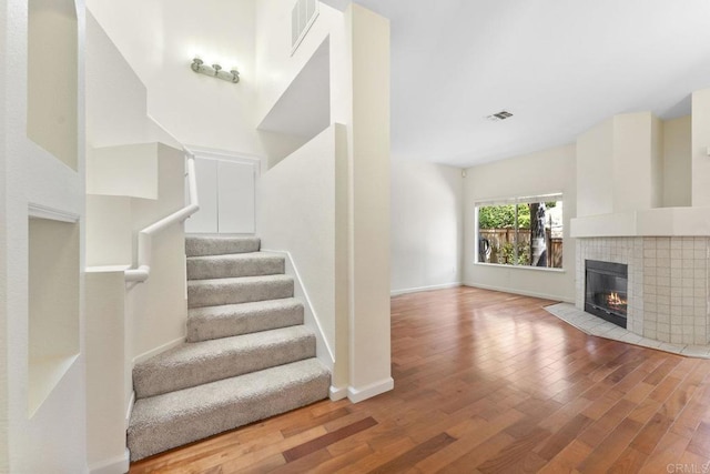 12032 Calle De Medio Unit 169, El Cajon, CA 92019 - stairs with wood finished floors and a tile fireplace