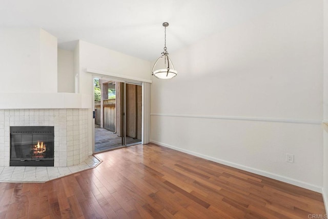 12032 Calle De Medio Unit 169, El Cajon, CA 92019 - unfurnished living room featuring wood finished floors and a tile fireplace