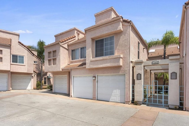12032 Calle De Medio Unit 169, El Cajon, CA 92019 - view of property with stucco siding, a tile roof, and a garage