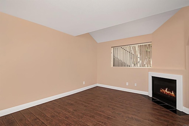 12672 Carmel Country Rd Unit 51, San Diego, CA 92130 - unfurnished living room featuring lofted ceiling, dark wood-style floors, and a fireplace with flush hearth