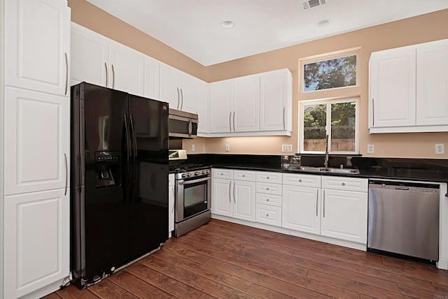 12672 Carmel Country Rd Unit 51, San Diego, CA 92130 - kitchen featuring stainless steel appliances, dark countertops, recessed lighting, and white cabinetry
