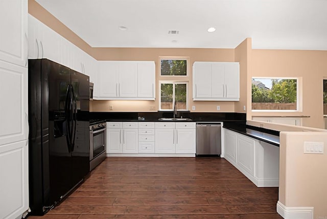 12672 Carmel Country Rd Unit 51, San Diego, CA 92130 - kitchen with appliances with stainless steel finishes, dark wood-style floors, dark countertops, white cabinets, and recessed lighting