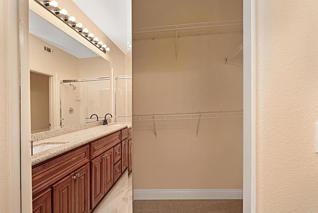 12672 Carmel Country Rd Unit 51, San Diego, CA 92130 - bathroom with a stall shower, double vanity, and a walk in closet