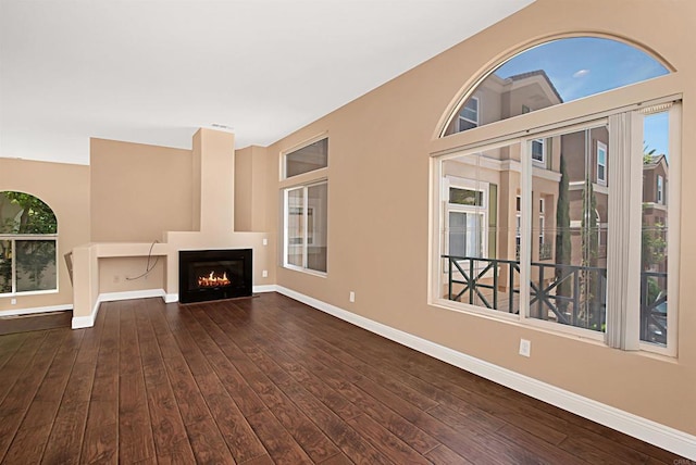 12672 Carmel Country Rd Unit 51, San Diego, CA 92130 - unfurnished living room with hardwood / wood-style floors and a warm lit fireplace