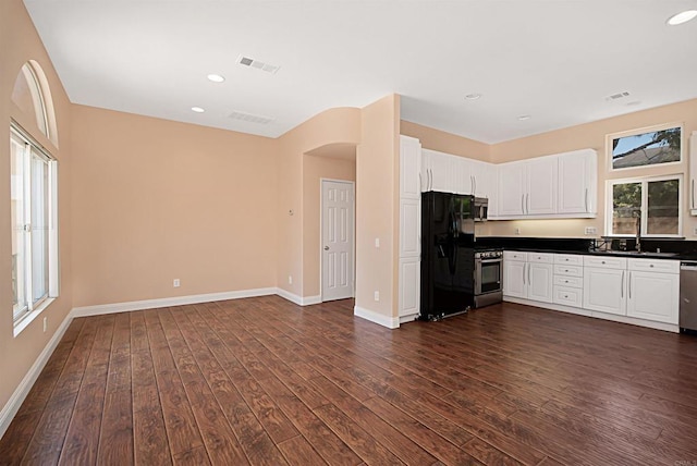 12672 Carmel Country Rd Unit 51, San Diego, CA 92130 - kitchen with stainless steel appliances, dark wood-type flooring, dark countertops, white cabinetry, and recessed lighting