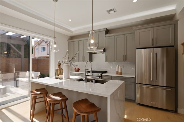 6023 Kauffman Ave, Temple City, CA 91780 - kitchen featuring high end fridge, gray cabinetry, decorative backsplash, under cabinet range hood, and recessed lighting