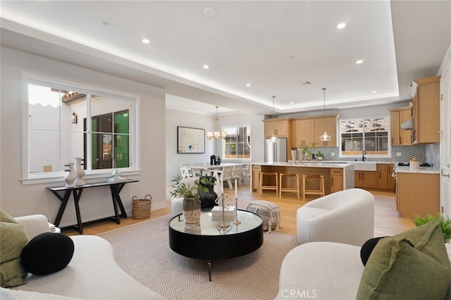 6023 Kauffman Ave, Temple City, CA 91780 - living area with a tray ceiling, light wood-style floors, recessed lighting, and a chandelier