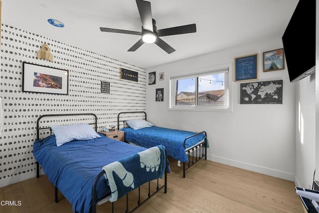 527 Keyser Rondo, Camarillo, CA 93010 - bedroom featuring an accent wall, wood finished floors, and a ceiling fan