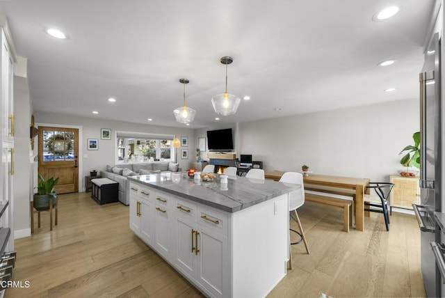 527 Keyser Rondo, Camarillo, CA 93010 - kitchen featuring open floor plan, light wood finished floors, a kitchen island, white cabinets, and recessed lighting