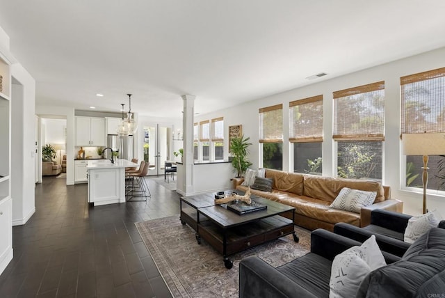 1480 Regatta Rd, Carlsbad, CA 92011 - living room with decorative columns, dark wood finished floors, and recessed lighting
