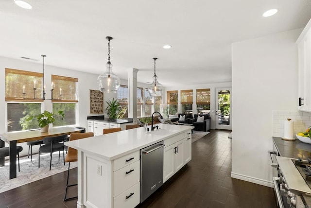 1480 Regatta Rd, Carlsbad, CA 92011 - kitchen featuring stainless steel dishwasher, a center island with sink, dark wood-style flooring, recessed lighting, and white cabinetry