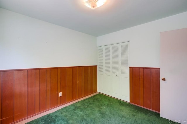 1970 El Prado Ave, Lemon Grove, CA 91945 - unfurnished bedroom featuring a closet, carpet floors, wooden walls, and wainscoting