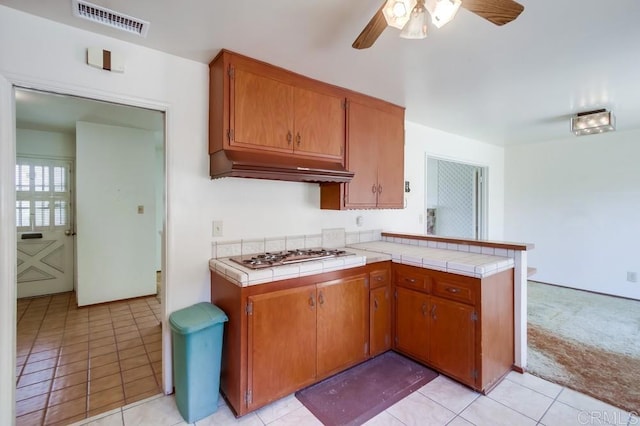 1970 El Prado Ave, Lemon Grove, CA 91945 - kitchen featuring gas stovetop, range hood, ceiling fan, tile counters, and a peninsula
