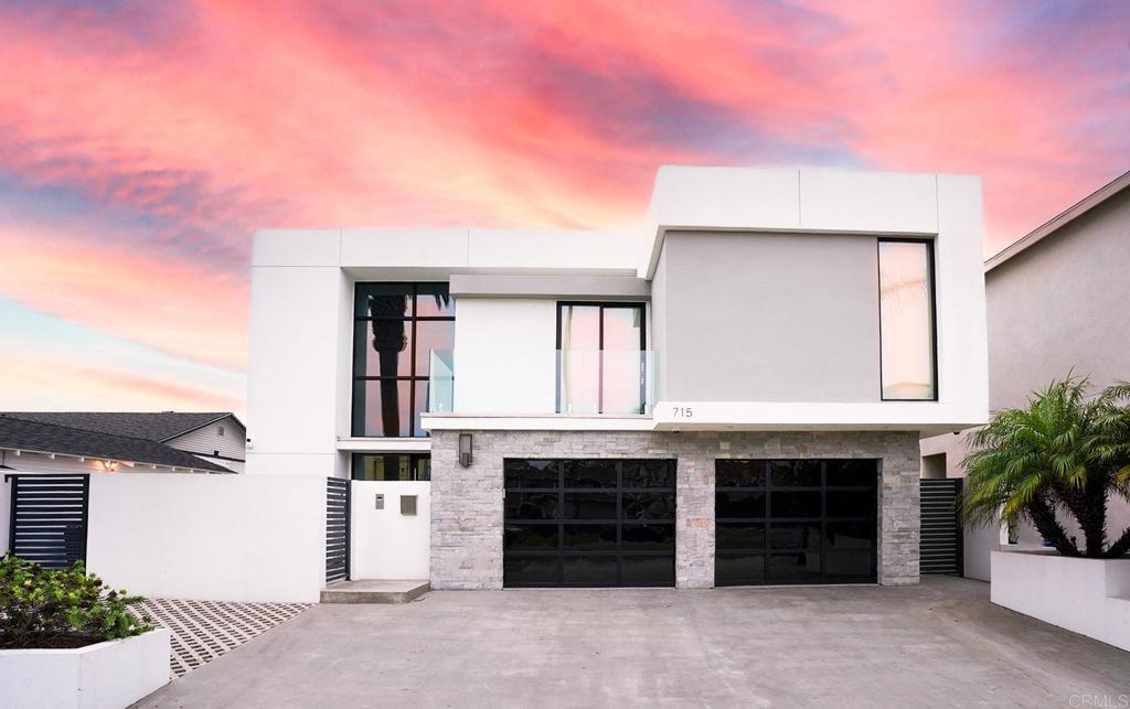 715 N Pacific St, Oceanside, CA 92054 - contemporary home with stucco siding, concrete driveway, a garage, and stone siding