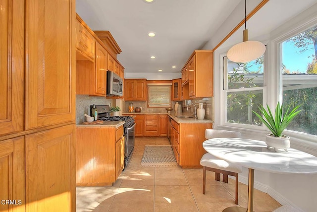 3671 Grayburn Rd, Pasadena, CA 91107 - kitchen with gas range oven, stainless steel microwave, backsplash, light countertops, and recessed lighting
