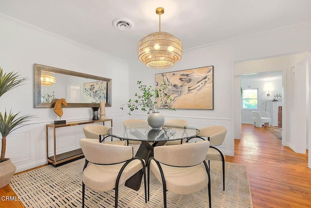 3671 Grayburn Rd, Pasadena, CA 91107 - dining area featuring light wood-type flooring, crown molding, and a chandelier